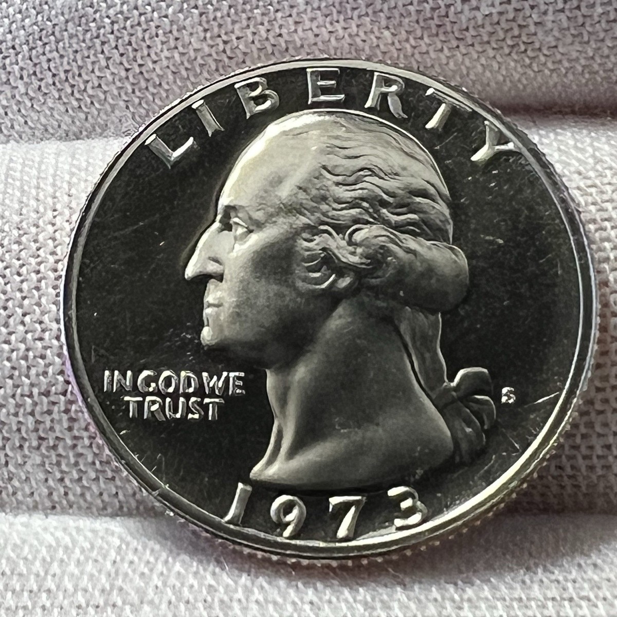1973-S Proof quarter comparison: standard proof left vs Deep Cameo DCAM right showing contrast difference