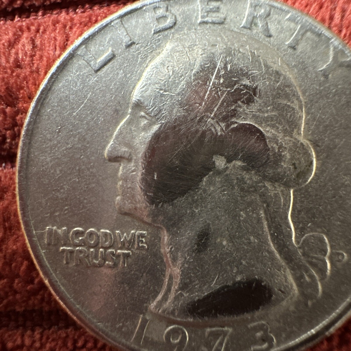 1973 quarter off-center strike error showing design shifted 25% with blank planchet crescent visible